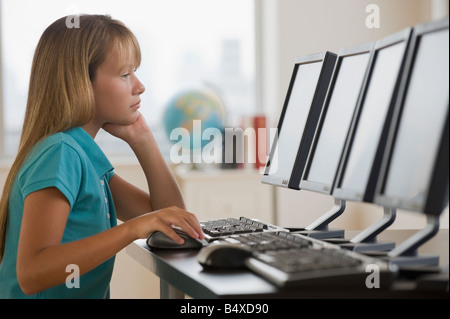 Girl using laptop in classroom Stock Photo