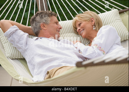 Couple relaxing in hammock Stock Photo