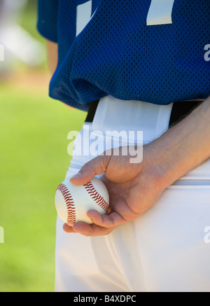 Baseball pitcher preparing to pitch ball Stock Photo