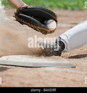 Close up of baseball player sliding into home plate Stock Photo