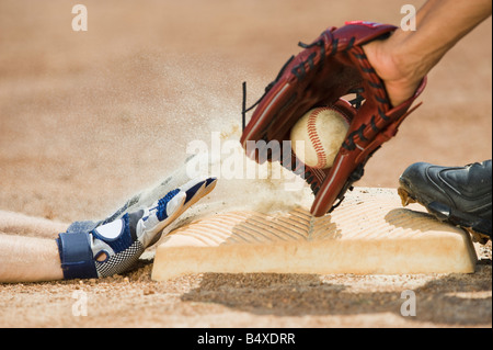 Baseball player sliding into home base Stock Photo