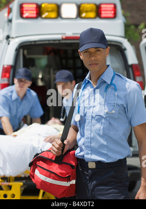 EMTs loading patient into ambulance Stock Photo