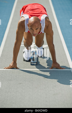 Runner on starter block Stock Photo