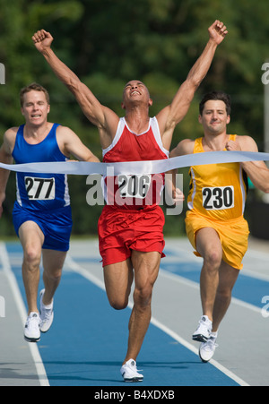 Runner Breaking Finish Line Tape Stock Photo - Alamy