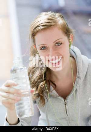Young woman drinking water after workout Stock Photo