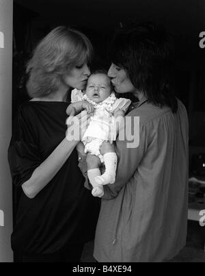 Ronnie Wood with his wife former model Jo Howard and their baby daughter Leah aged five weeks making her debut in a hotel in Los Angeles after they had been forced to leave their Malibu home after a series of fires in the area Stock Photo