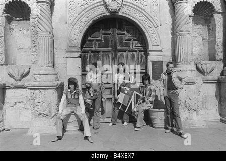 Rolling Stones Bill Wyman Keith Richards Mick Jagger Ronnie Woods and Charlie Watts stand outside the gate of the Alamo while on tour in the USA Stock Photo