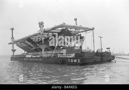 Raising The Mary Rose October 1982 The wreck of the Mary Rose King Henry VIII flagship which sunk in 1545 seen here on its salvage barge after being lifted from the seabed of Southsea Stock Photo