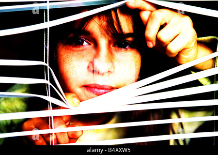 Girl looking through window Stock Photo