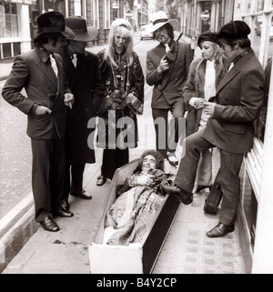 Unusual The Death of the Hippie in Lexington Street London near Carnaby Street Colin Bennett in the coffin playing - Stock Photo