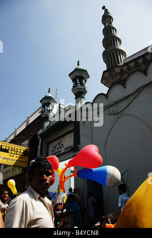 Man selling balloons outside Muslim Mosque and Western Union office in Kathmandu Nepal Stock Photo