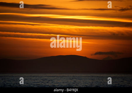 sunset over the fanad peninsula of county donegal republic of ireland as seen from portstewart county londonderry ireland Stock Photo