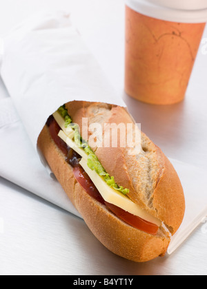 Cheddar Cheese, Pickle And Salad Baguette With A Take Away Coffee Stock Photo