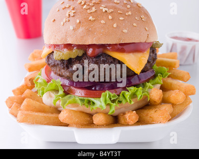 Cheese Burger In A Sesame Seed Bun With Fries Stock Photo