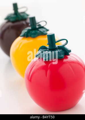 Three Tomato Shaped Sauce Bottles Stock Photo