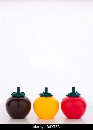 BBQ, Mustard And Ketchup Sauce Bottles, Three Tomato Shaped Sauce Bottles Stock Photo