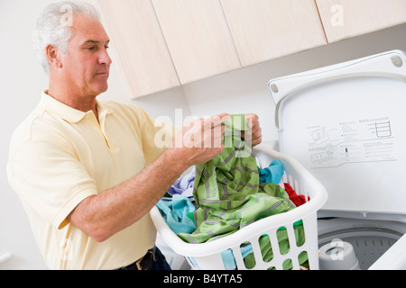 Man Reading Washing Instructions Stock Photo