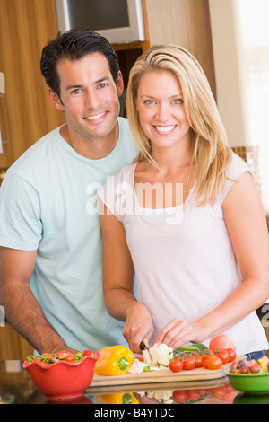 Husband And Wife Preparing Meal Together Stock Photo