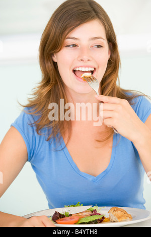 Young Woman Enjoying Meal Stock Photo