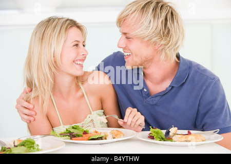 Young Couple Enjoying Meal Together Stock Photo