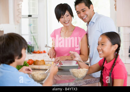 Family In Kitchen Eating Breakfast Stock Photo