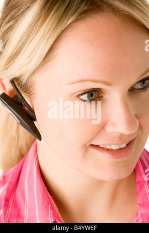 Businesswoman Talking On Hands Free Phone Stock Photo