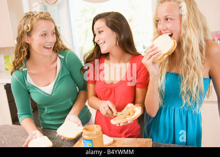 Teenage Girls Making Sandwiches Stock Photo