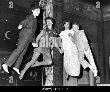 Peter Pan takes off Dawn Addams second from left with Alison Frazer as Wendy David Morris as John and Douglas Mann extreme right as Michael rehearse their flying act on the stage of the Scala Theatre London The show comes to Newcastle in March Stock Photo