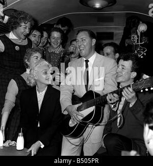 Bill Haley on his first visit to England which was largely sponsored by the Daily Mirror Rocking fans on the train with Bill coming from Southampton to Waterloo station Stock Photo