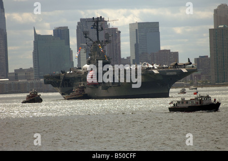 The Intrepid Sea Air Space Museum is towed up the Hudson River on it s return journey to its pier Stock Photo