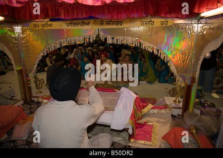 Sikh man and woman during marriage ceremony in temple or gurdwara Stock Photo