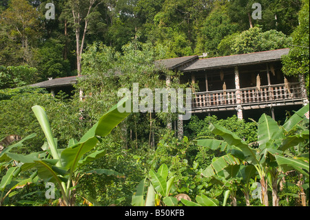 A tribal longhouse in forest at the Sarawak Cultural Village Damai nr Kuching Sarawak Malaysia Stock Photo