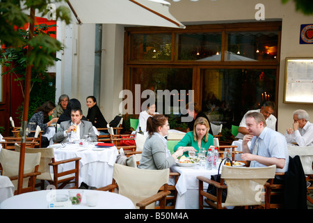 Sep 2008 People sitting at an outdoors restaurant on Kamergersky pereulok Street next to Tverskaya Ulitsa street Moscow Russia Stock Photo
