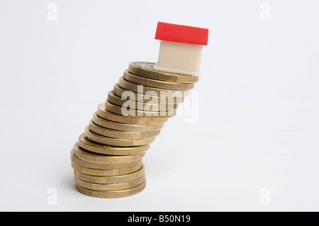 Miniature house on stack of coins, symbolic image real estate Stock Photo