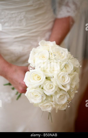 Bride holding bridal bouquet made of roses Stock Photo