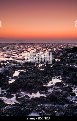 Sunset over the mudflats at Sand Point near Weston-super-Mare, with Steep Holm Island visible on the horizon. Stock Photo