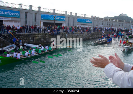 Rowers leaving to begin a sea regatta in San Sebastian Stock Photo