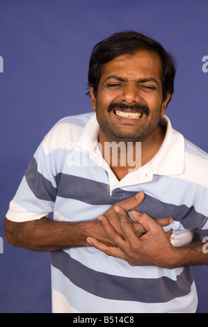 Indian man having a heart attack Stock Photo