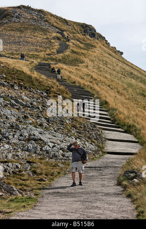 Tourists trek up and down the Puy Mary volcano, France Stock Photo