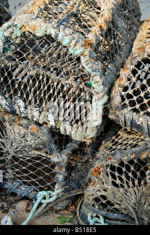 Lobster pots stacked on the quayside in Tenby Stock Photo