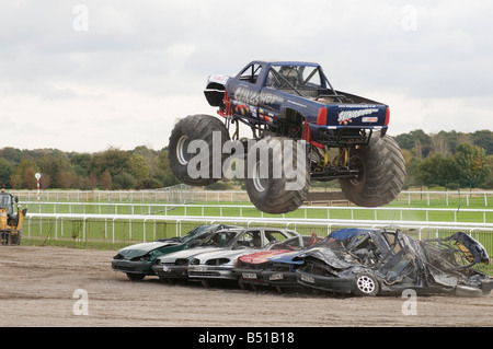 monster truck jumping crushed cars in a race Stock Photo