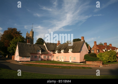 Cavendish in Suffolk showing traditional pink thatched cottages and village green Stock Photo