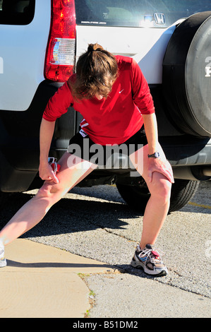 Woman stretches out before running for health. USA. Stock Photo