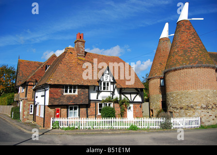Oast Houses by cottage, Heaverham, Kent, England, United Kingdom Stock Photo