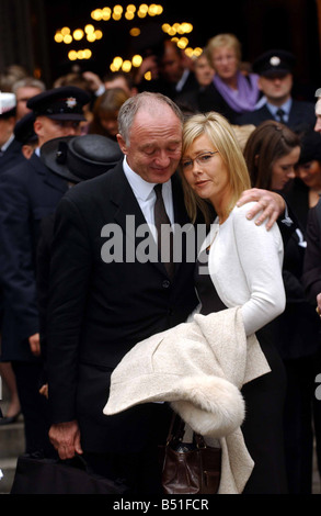 London Mayor Ken Livingstone comforts Michele the widow of Bill Faust after the memorial service for firefighters Bill Faust and Adam Meere at Westminster Cathedral Stock Photo