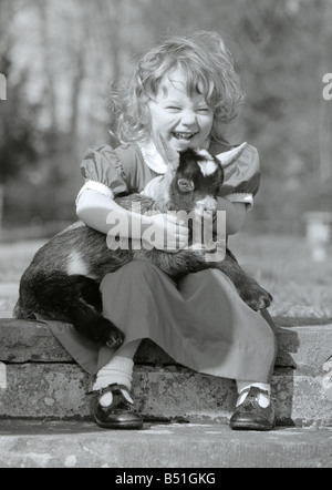 Candida 2 with Skippy the three week old pygmy goat at the kilverstone wildlife park in Norfolk Candida is the grand daughter of Lord and Lady Fisher Chilren cute with animals May 1981 Stock Photo