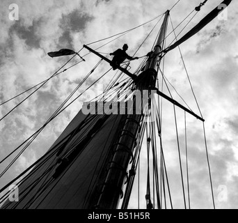 S. L. C. Latham, aged 17, astride the cross tree helping to send up the top mast a board the school of navigation 103 ton seagoing training vessel Moyana in the Solent, Southampton. May 1948 P000153; Stock Photo