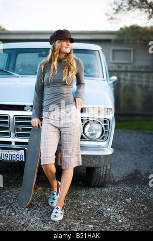 Portrait of Skateboarder Leaning Against Truck, Mill Valley, Marin County, California, USA Stock Photo