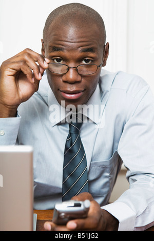 Businessman Looking Above Eyeglasses Stock Photo