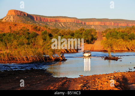 Vehicle Crossing Pentecost River with Cockburn Ranges in Background, Gibb River Road, Kimberley, Western Australia Stock Photo